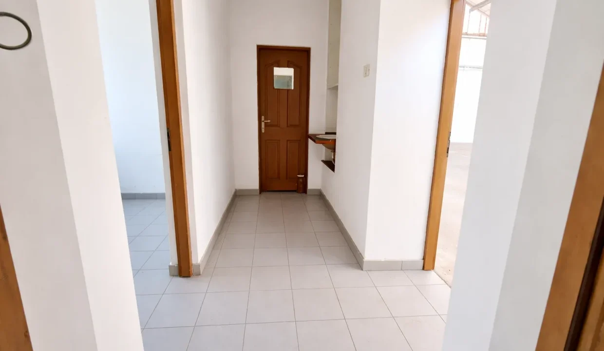 Bright hallway with wooden door