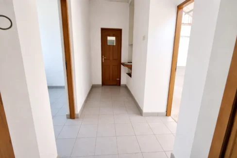 Bright hallway with wooden door