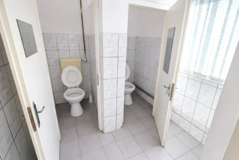 Clean public restroom with open stalls