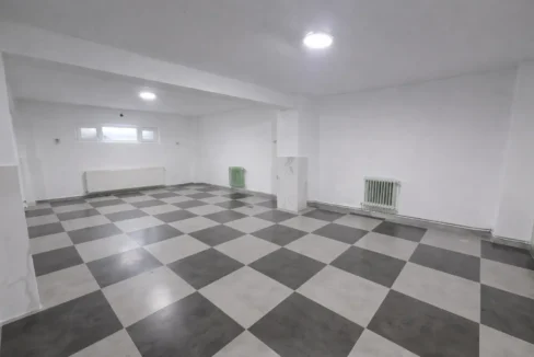 Empty basement with checkerboard floor