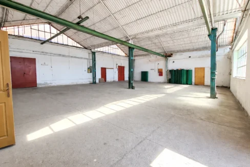 Industrial warehouse interior with sunlight (1)
