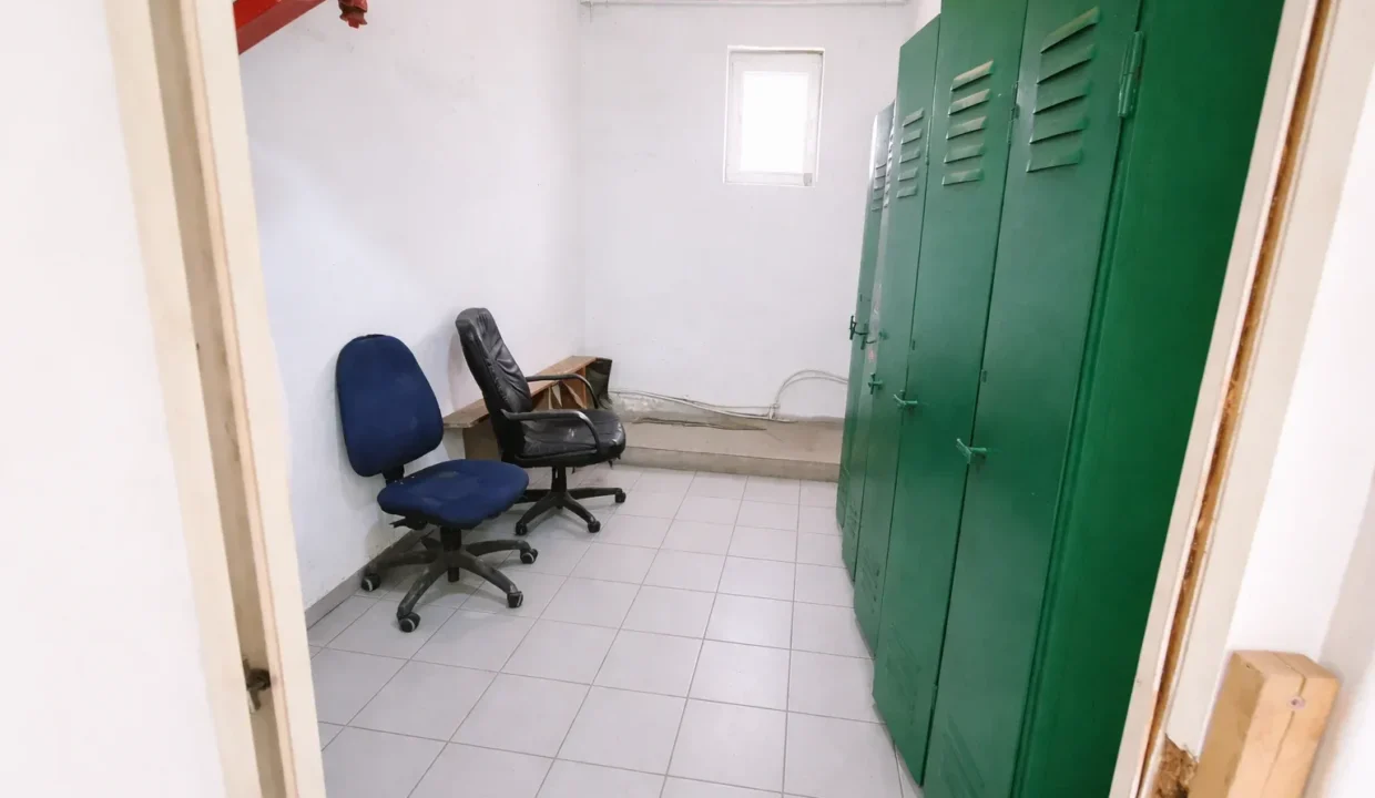 Utility room with office chairs and lockers