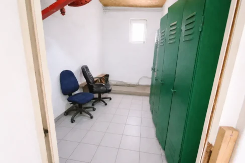 Utility room with office chairs and lockers